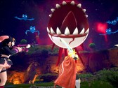 Una schermata di Palworld mostra i personaggi che combattono contro un bulbo oculare fluttuante con denti affilati
