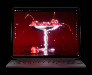 Apple iPad Pro M5 con Tastiera Magica che mostra un rendering 3D di ciliegie, mettendo in evidenza il display OLED Ultra Retina XDR e la grafica del chip M5 (Fonte immagine: Apple)