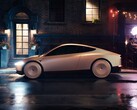 Tesla Cab parcheggiata in una strada cittadina bagnata di notte, caratterizzata da un design elegante e futuristico con ruote coperte. (Fonte: Tesla)