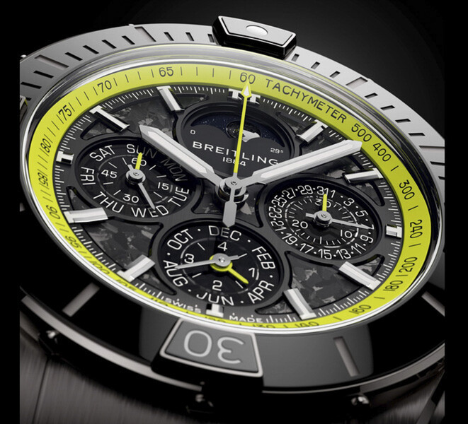 Primo piano del Breitling Super Chronomat B19 44 Perpetual Calendar Chronograph che mostra il quadrante in fibra di carbonio, i contatori del calendario, le lancette color argento e la scala tachimetrica verde lime.