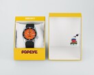 Orologio automatico Seiko 5 Sports x Popeye HDB013 con quadrante arancione, accanto alla sua confezione gialla in edizione limitata.
